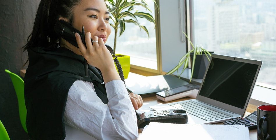 A girl happily working at her workstation